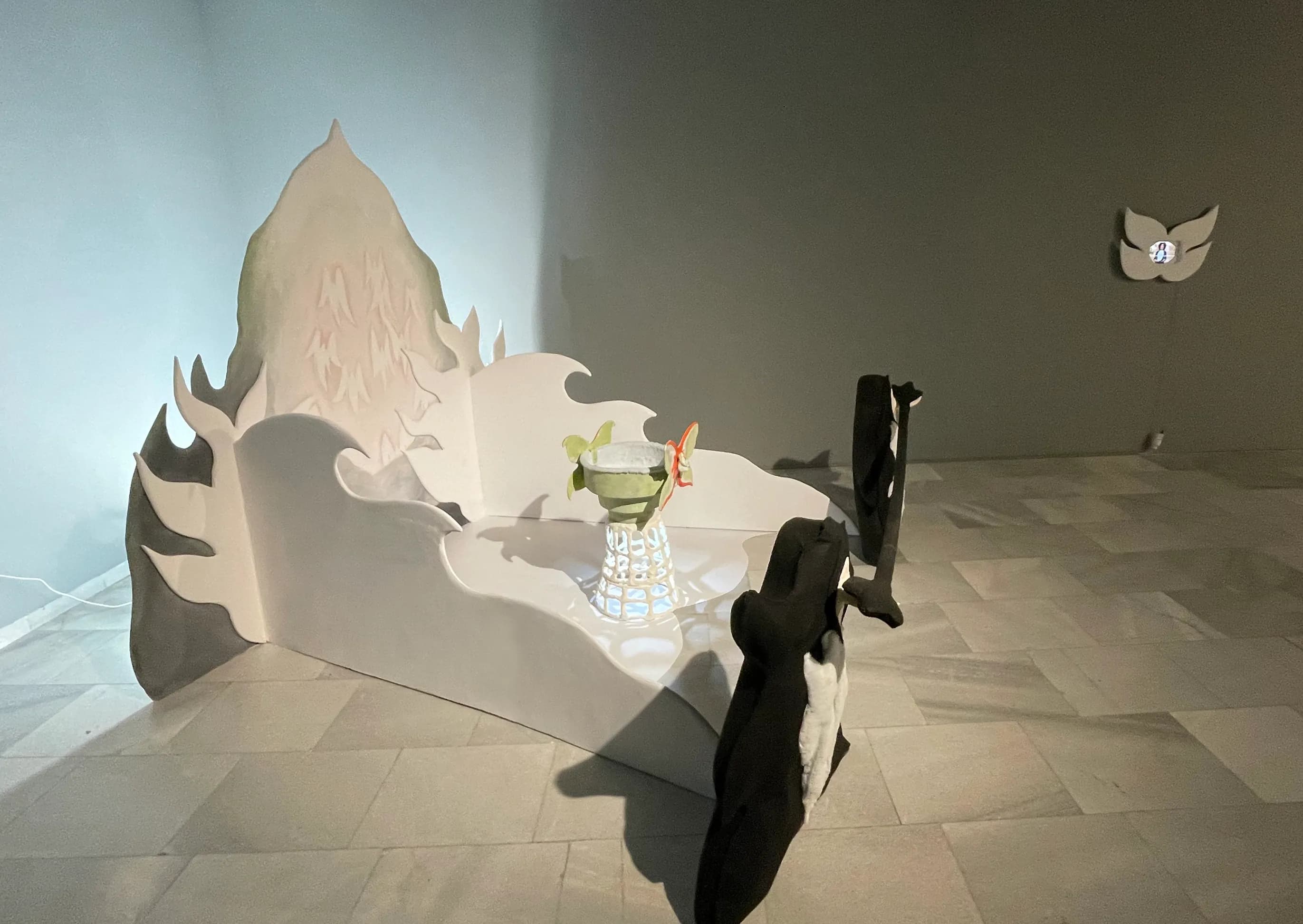 Side-angle installation view of the same gallery corner