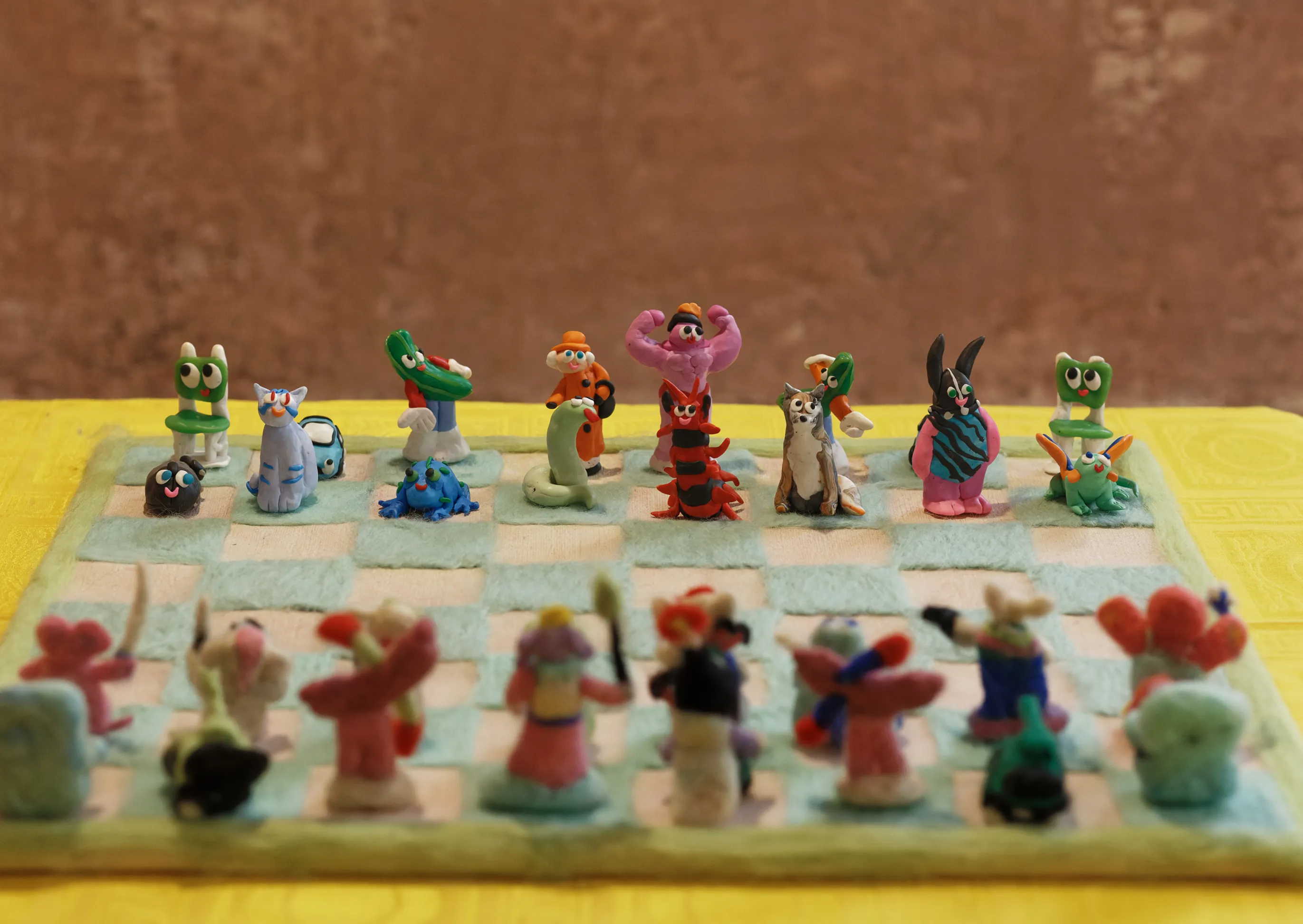 Further detail of the clay chess pieces on the felt board